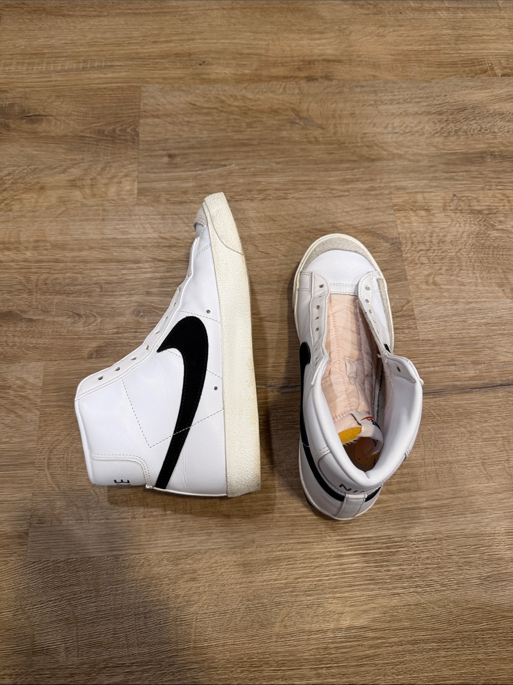 Nike White High-Top Sneakers with Black Swoosh
